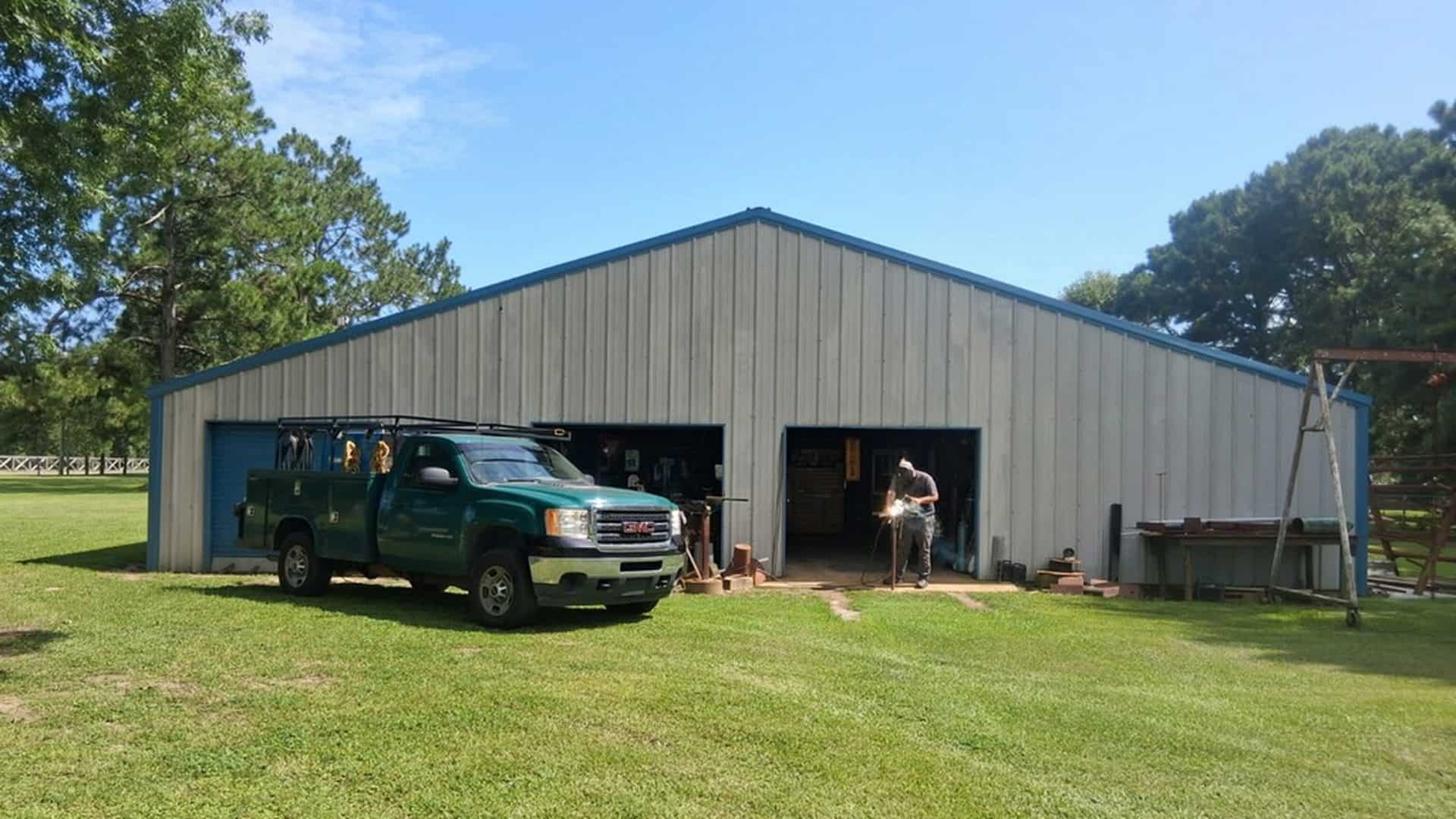 The Albert's Specialty Welding shop in Irvington, Alabama — the green service-bed welding truck parked outside and a welder working in the open bay.